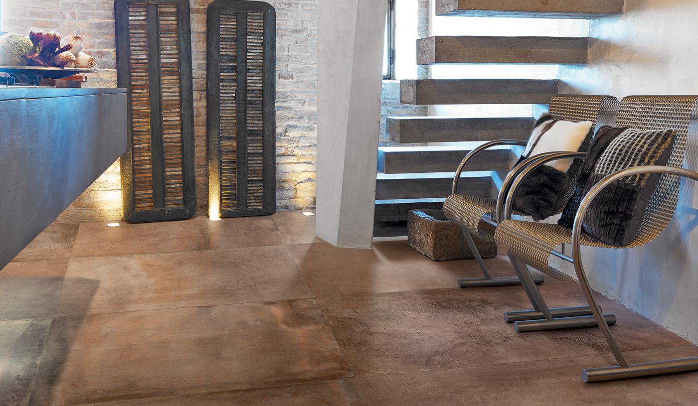 Modern interior with Emil Viva Acustico porcelain tile flooring in a warm brown tone, showcasing stylish furniture and elegant staircase design