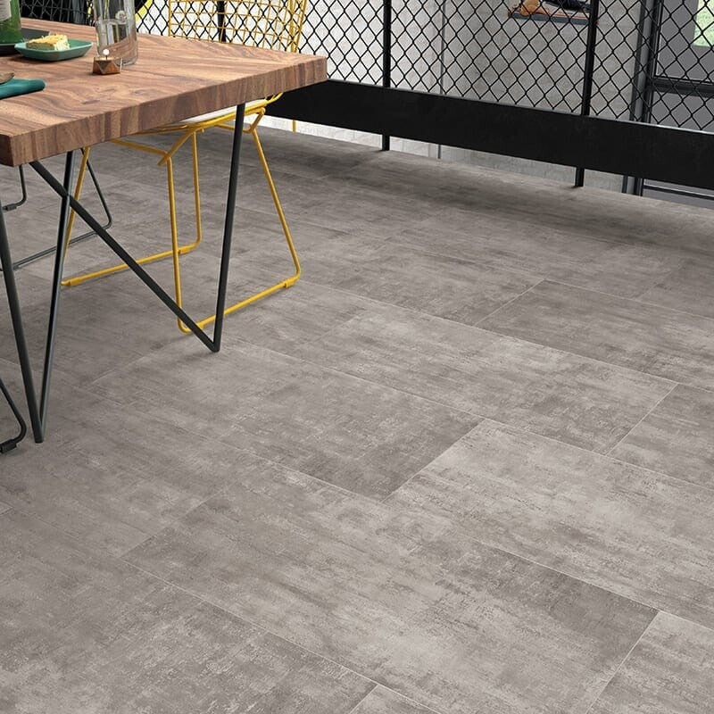 Modern room with gray concrete tiles, wooden table, black metal legs, and yellow chairs. Stylish and contemporary design.