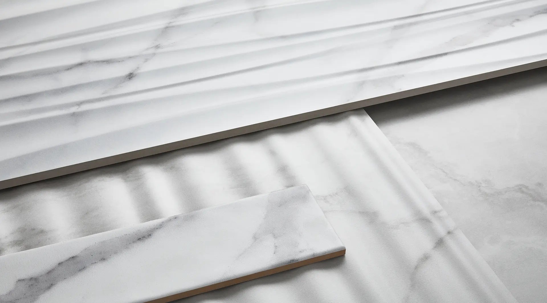 Elegant modern bathroom featuring Anatolia Raffino porcelain tile collection with marble design, showcasing dual vessel sinks on a wooden vanity.