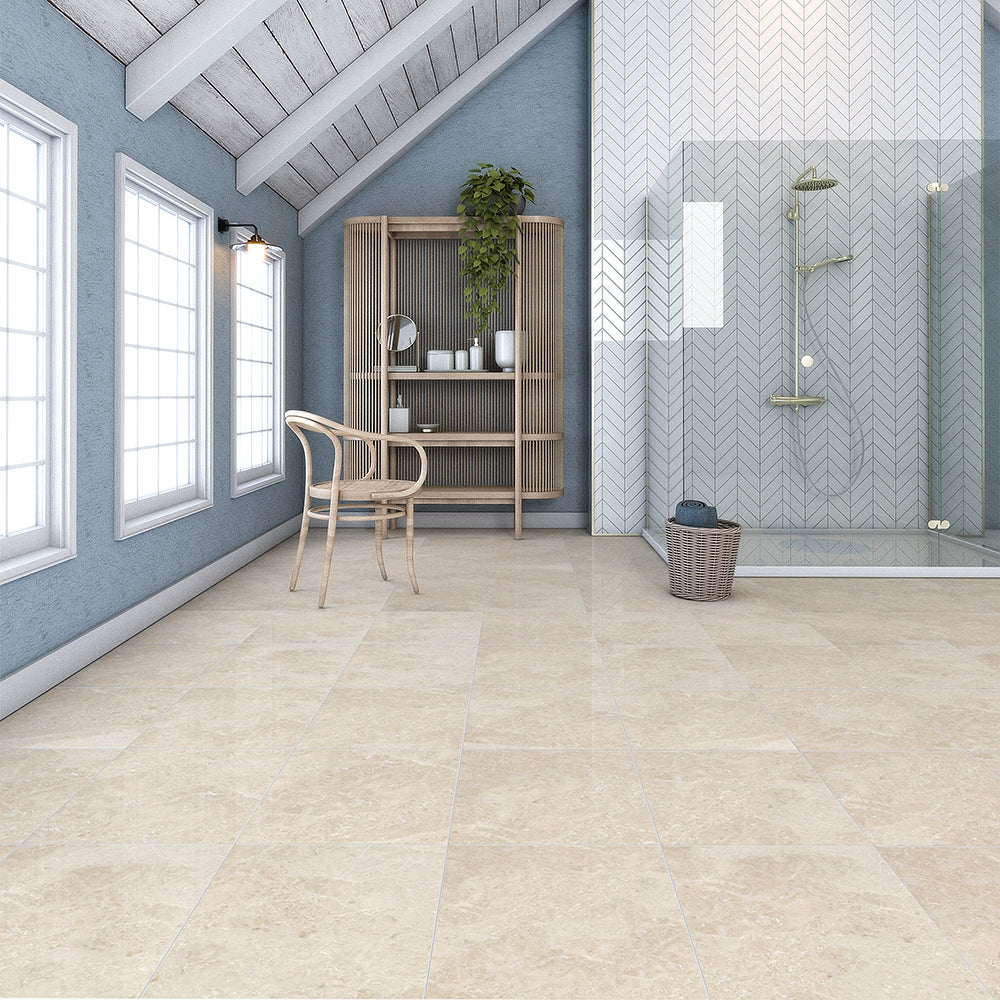 Bright, spacious room with cappuccino marble tiles, large windows, wooden chair, shelf with plants, and glass-enclosed shower with herringbone tile.