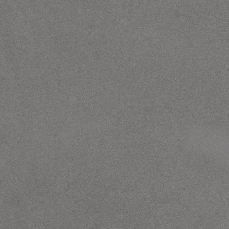 A close-up image of a porcelain tile with a slightly textured surface, exhibiting a uniform, muted blue-gray color and subtle variations in shade that give a natural stone-like appearance.