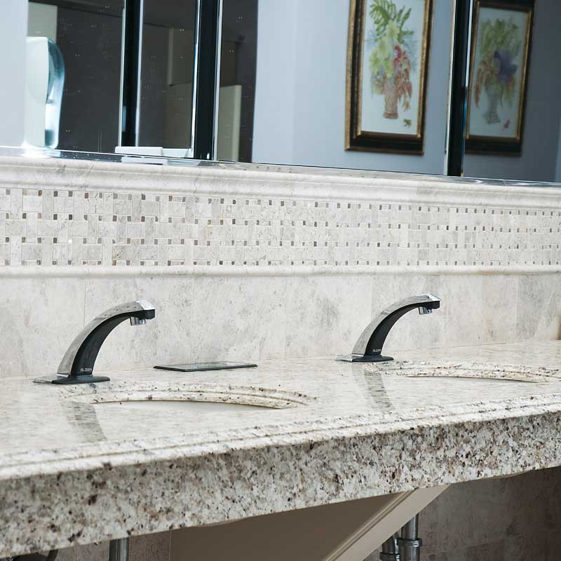 Double sink bathroom vanity with silver cloud marble countertop, modern black faucets, and framed artwork on the wall.