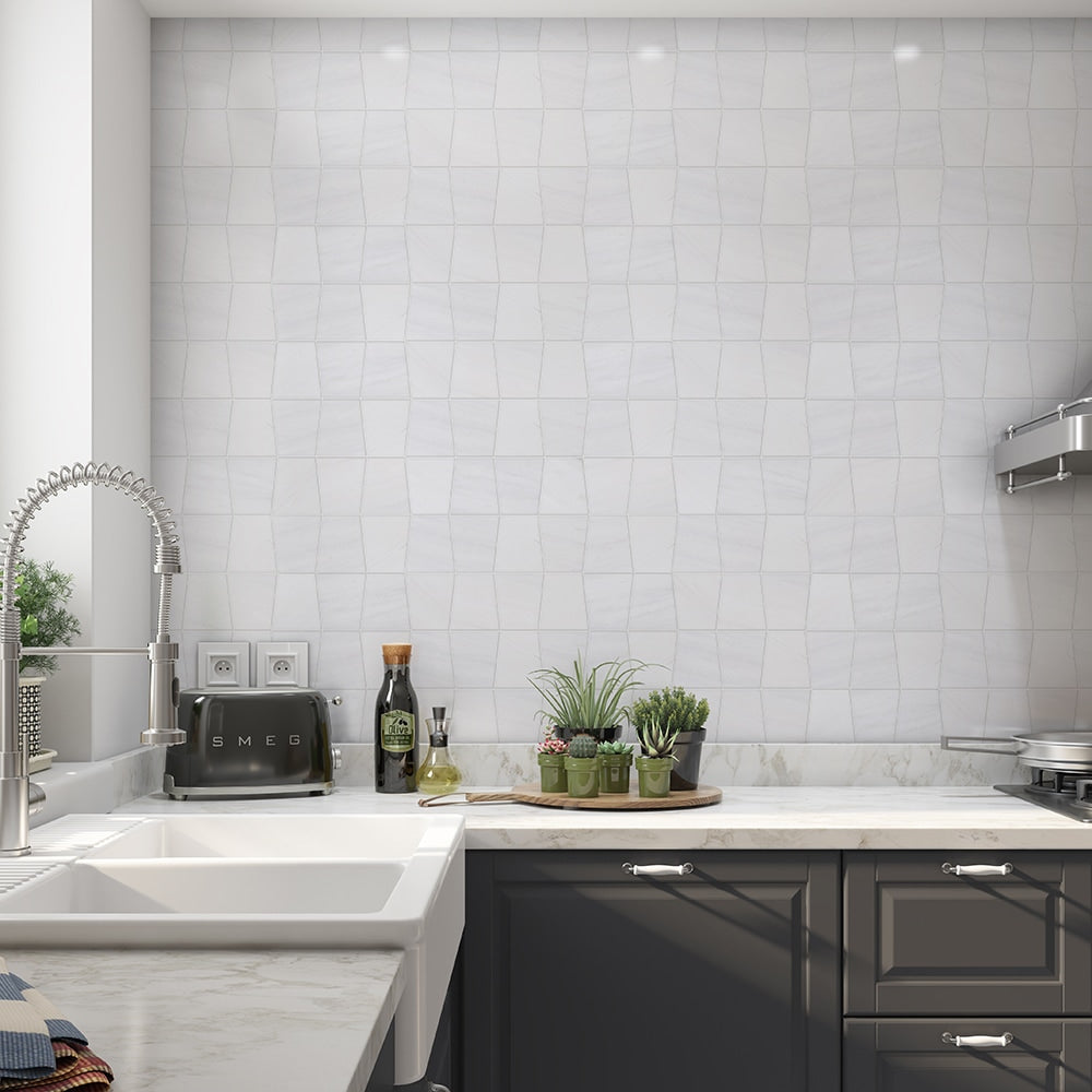 Modern kitchen with white marble backsplash, stainless steel appliances, and dark gray cabinets for a sleek and contemporary look.