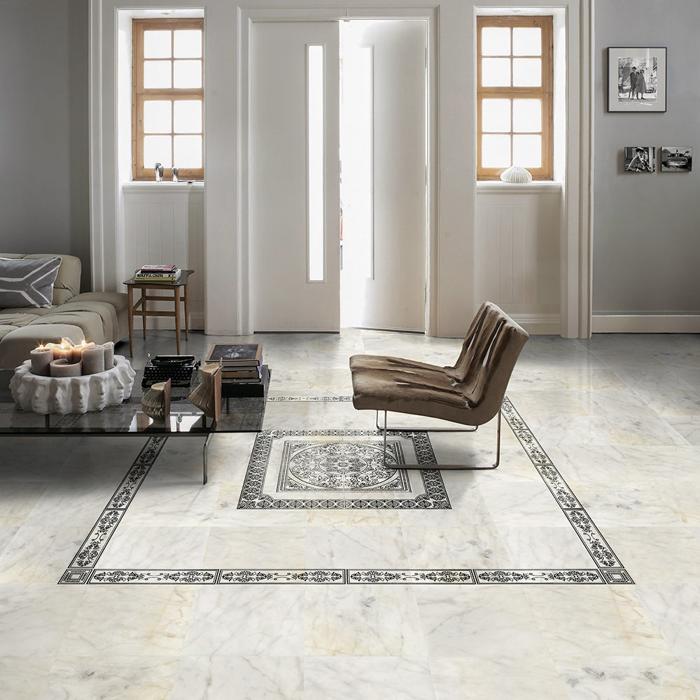 Luxurious living room with white marble flooring, modern furniture, large windows for natural light. Black and white patterned inlay adds style.