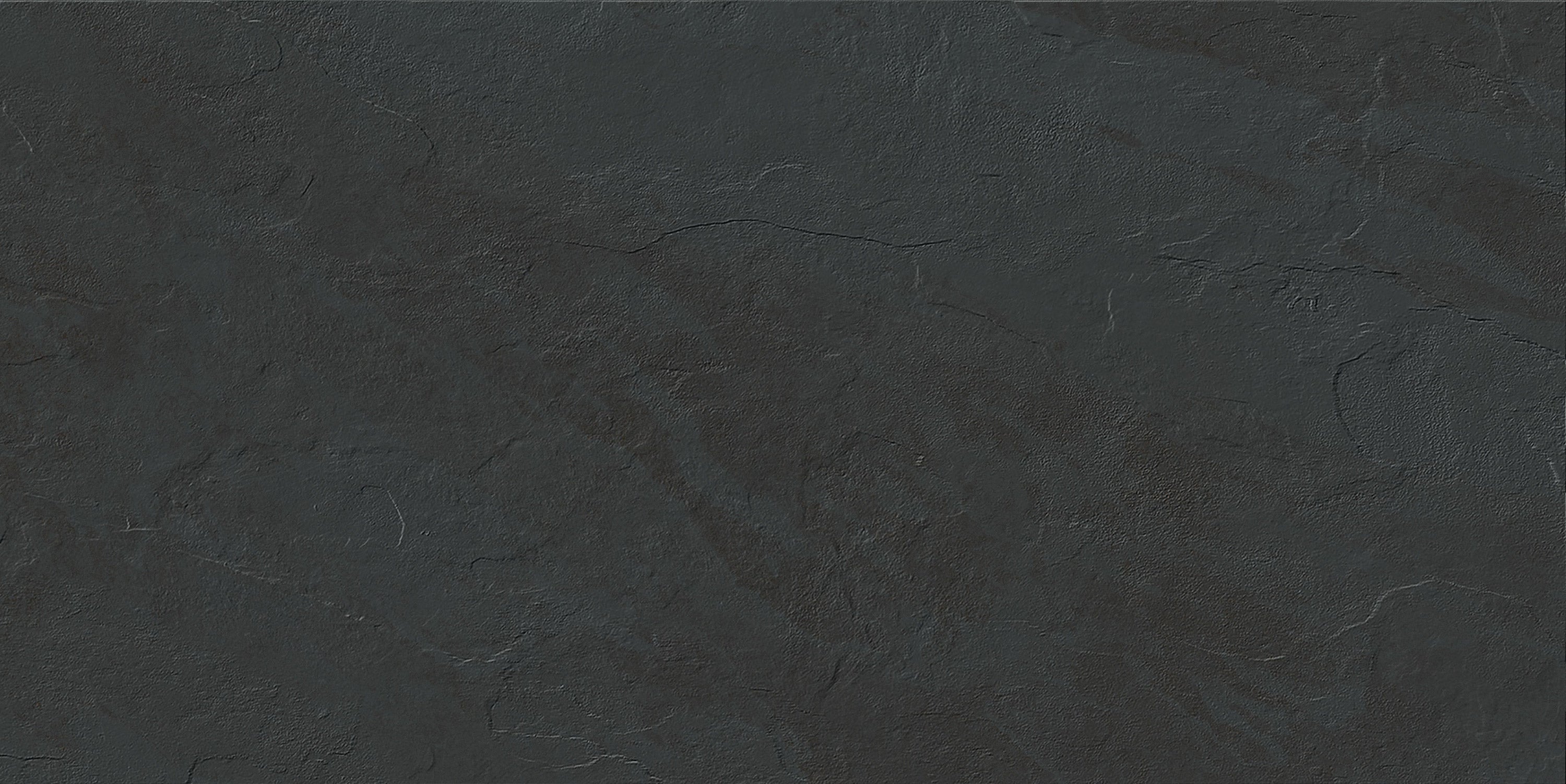 Essence Montauk Black porcelain pavers, top-down product view, 12"×24"×11/32" size. Premium porcelain for floors and walls.