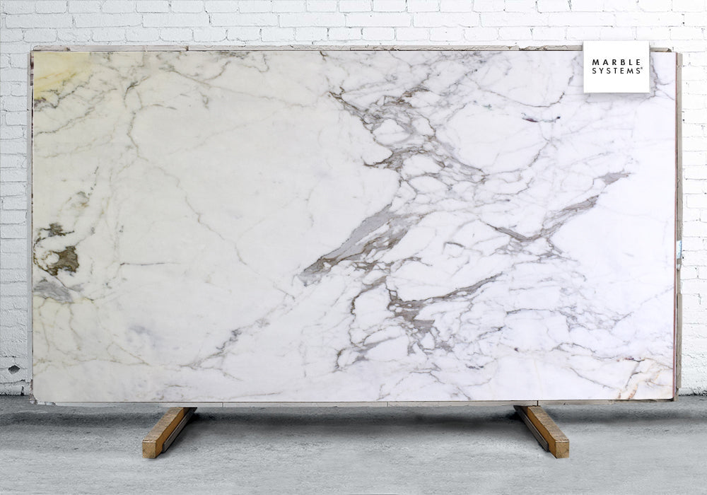 Marble Slabs Calacatta Gold Supreme marble slabs, top-down product view. Premium marble for floors and walls.
