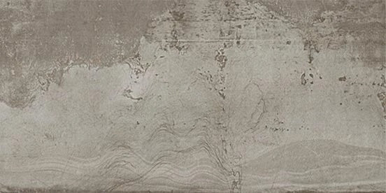 Weathered aluminum-look porcelain tile with a hammered, oxidized finish in matte gray, evoking industrial strength and urban authenticity.