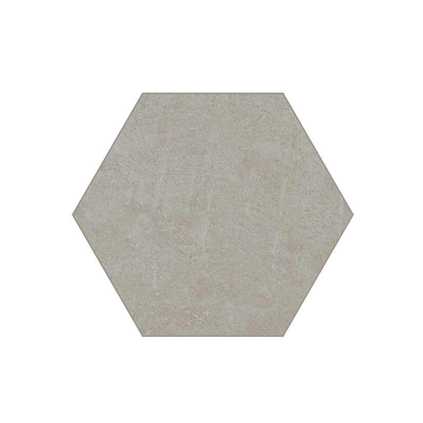 Hexagonal matte porcelain tiles in soft pebble gray with delicate handcrafted reliefs and subtle urban concrete texture.