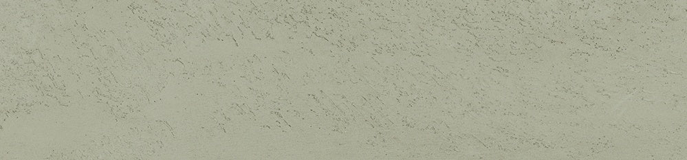 Smooth matte porcelain tile in soft ash gray, evoking raw earth with a contemporary minimalist warmth.
