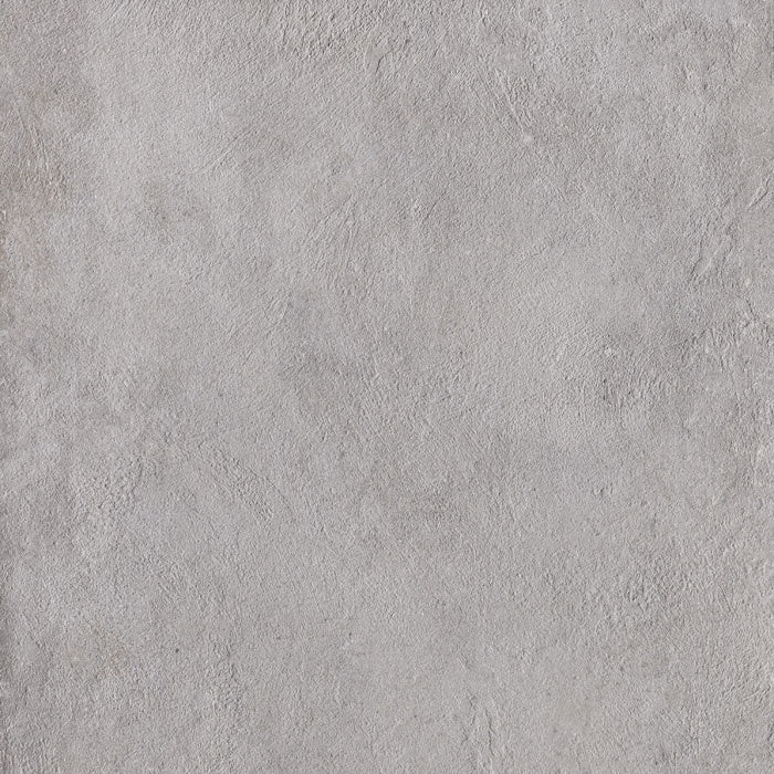 Large-format matte gray porcelain tile with refined concrete texture, exuding urban minimalism and brutalist elegance in a monolithic square.