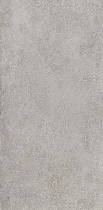 A sleek, full-body porcelain tile in cool concrete gray with refined mineral texture and subtle urban sophistication for modern interiors.