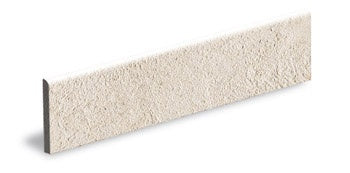 Matte almond bullnose trim in full-body porcelain, embodying urban minimalism with refined concrete texture and warm neutral tones.