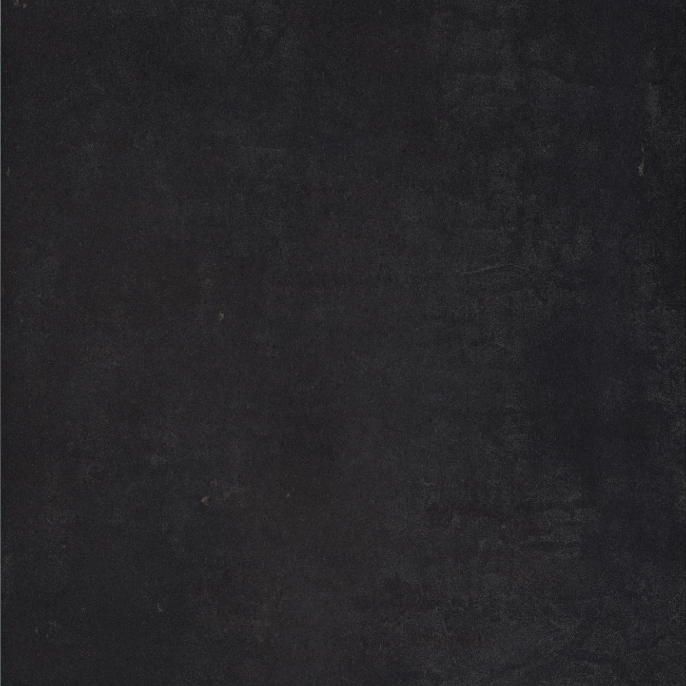 Black full-body porcelain tile with a matte finish, sleek modern elegance for refined residential and commercial interiors.