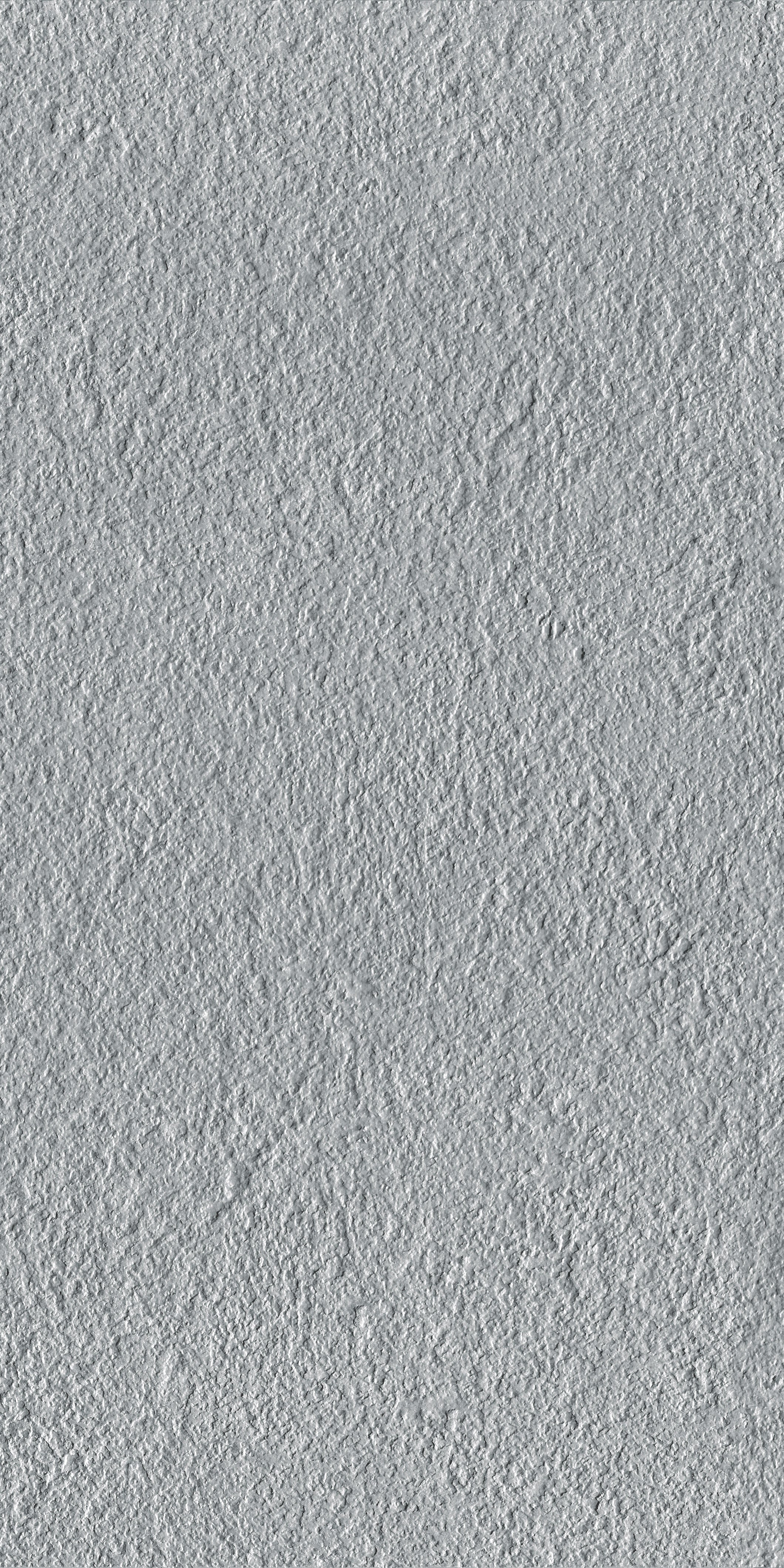 Bush-hammered gray porcelain tile with a matte, rustic texture, exuding modern sophistication and timeless minimalist elegance.