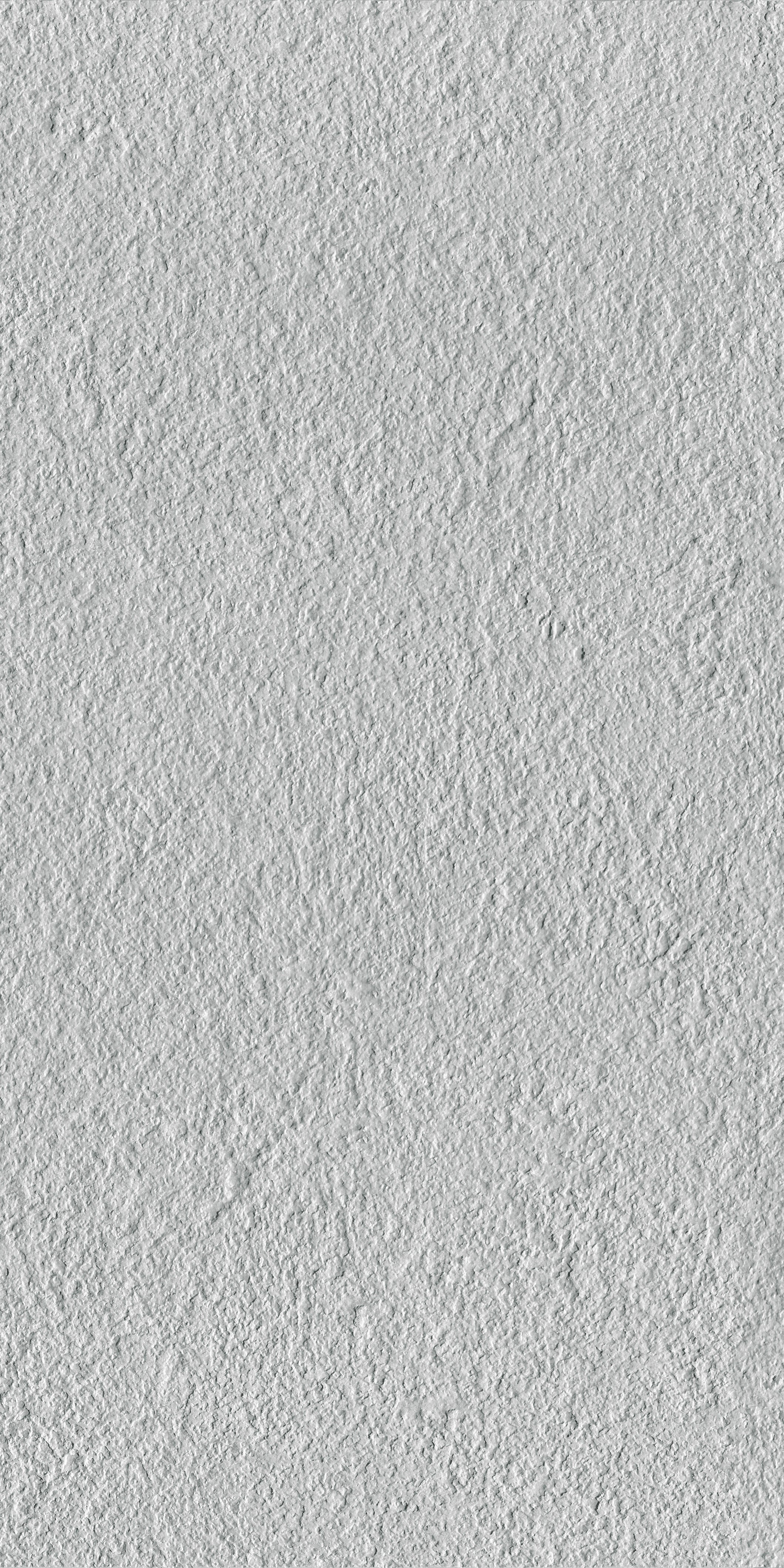 Matte bush-hammered porcelain tile in soft ice gray, full-body texture for a sleek, minimalist look with rustic sophistication.