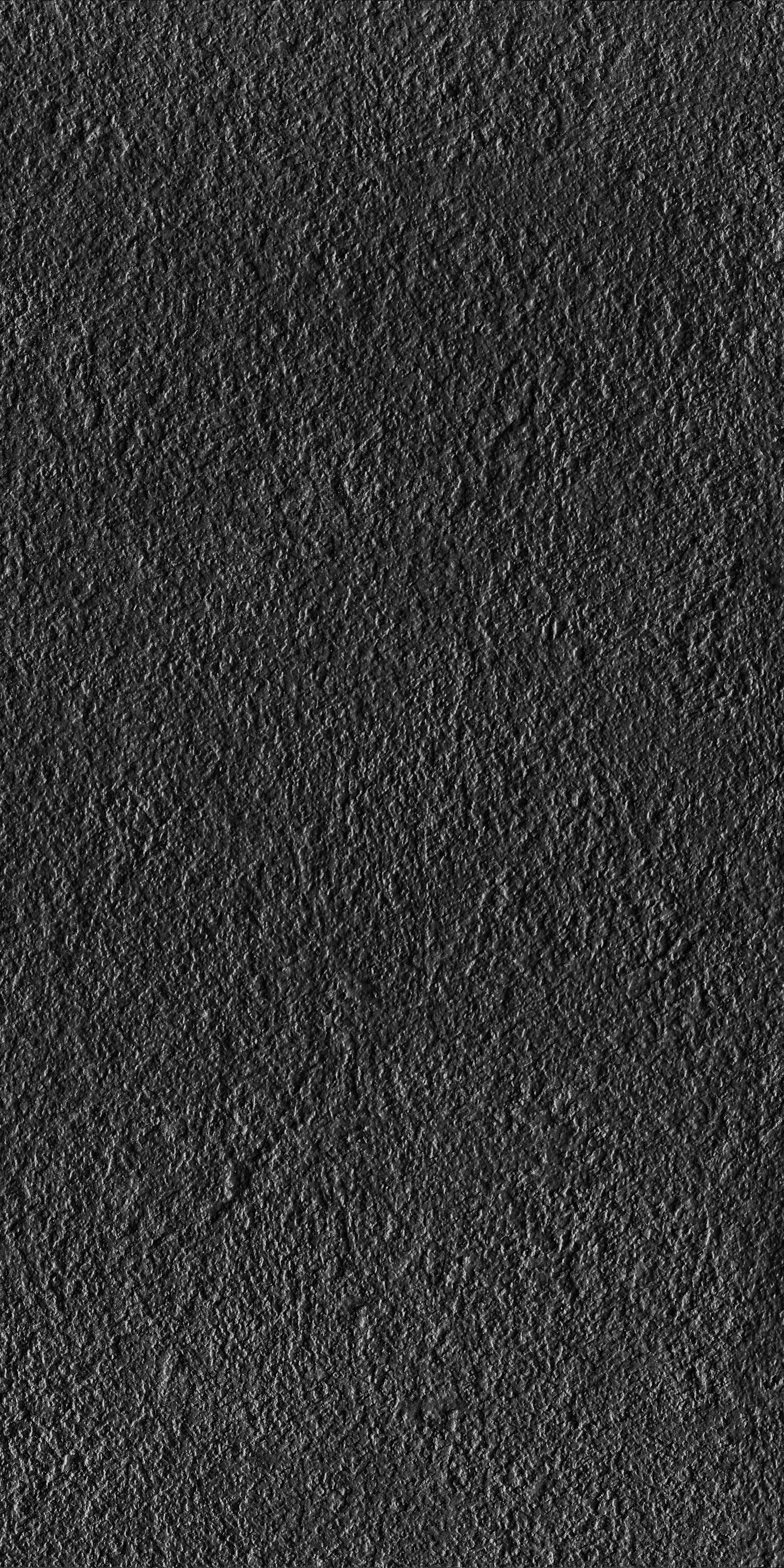 Black full-body porcelain tile with a bush-hammered rustic texture, matte finish, and sleek modern elegance for refined interiors.