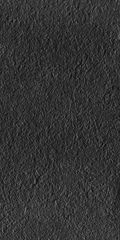 Black full-body porcelain tile with a bush-hammered rustic texture, matte finish, and sleek modern elegance for refined interiors.