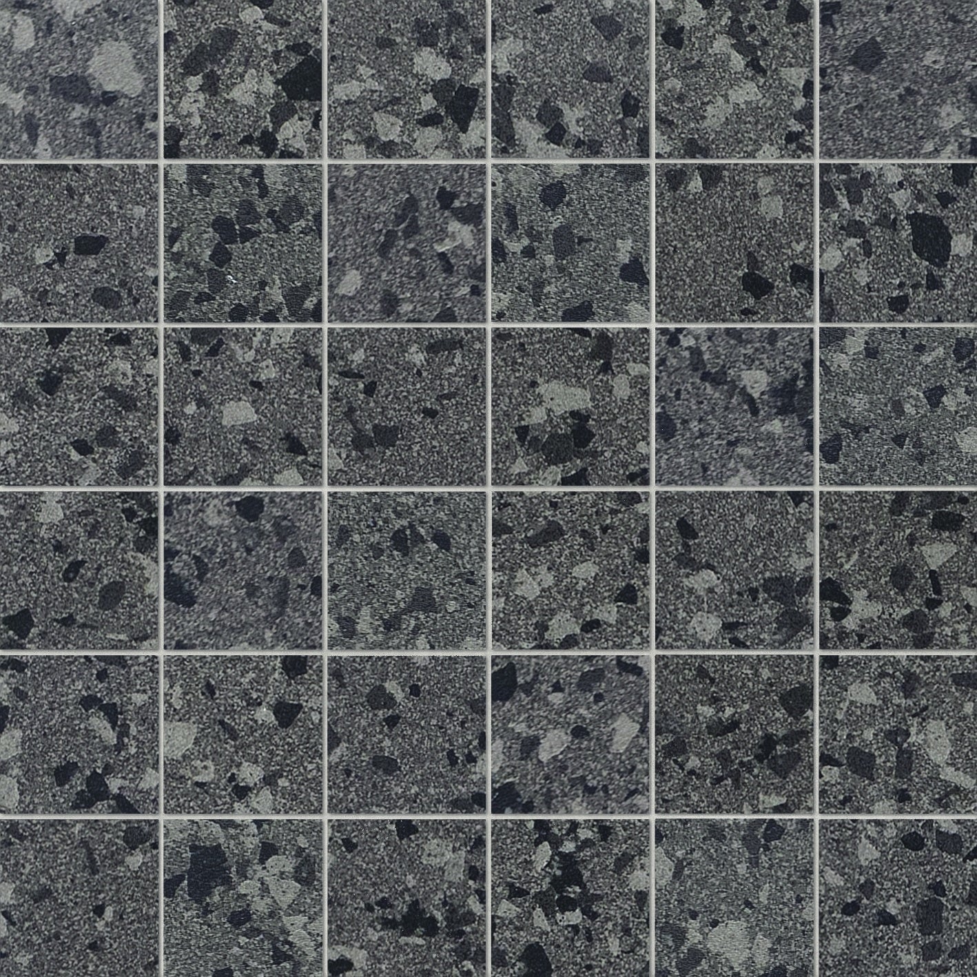 Dark gray terrazzo-effect porcelain mosaic with medium grains, matte texture, and refined industrial elegance for timeless interiors.