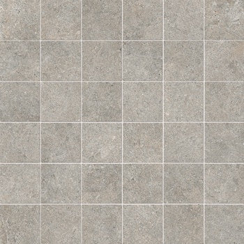Full-body porcelain mosaic in dove grey, matte stone-like texture, interlocking squares for serene minimalist elegance.