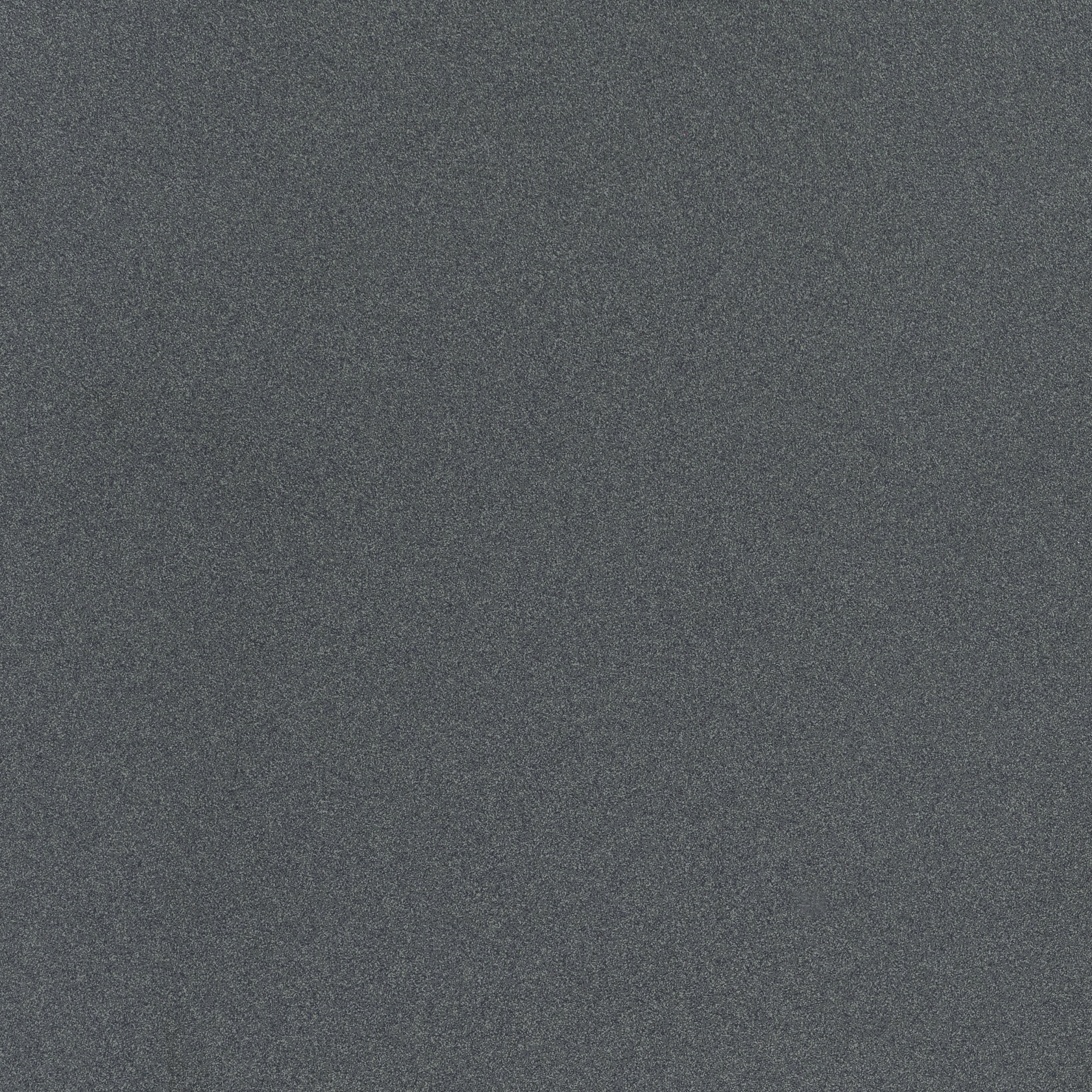 A large-format dark gray terrazzo-look porcelain tile with fine, organic grain detailing and a soft matte finish, radiating understated elegance.