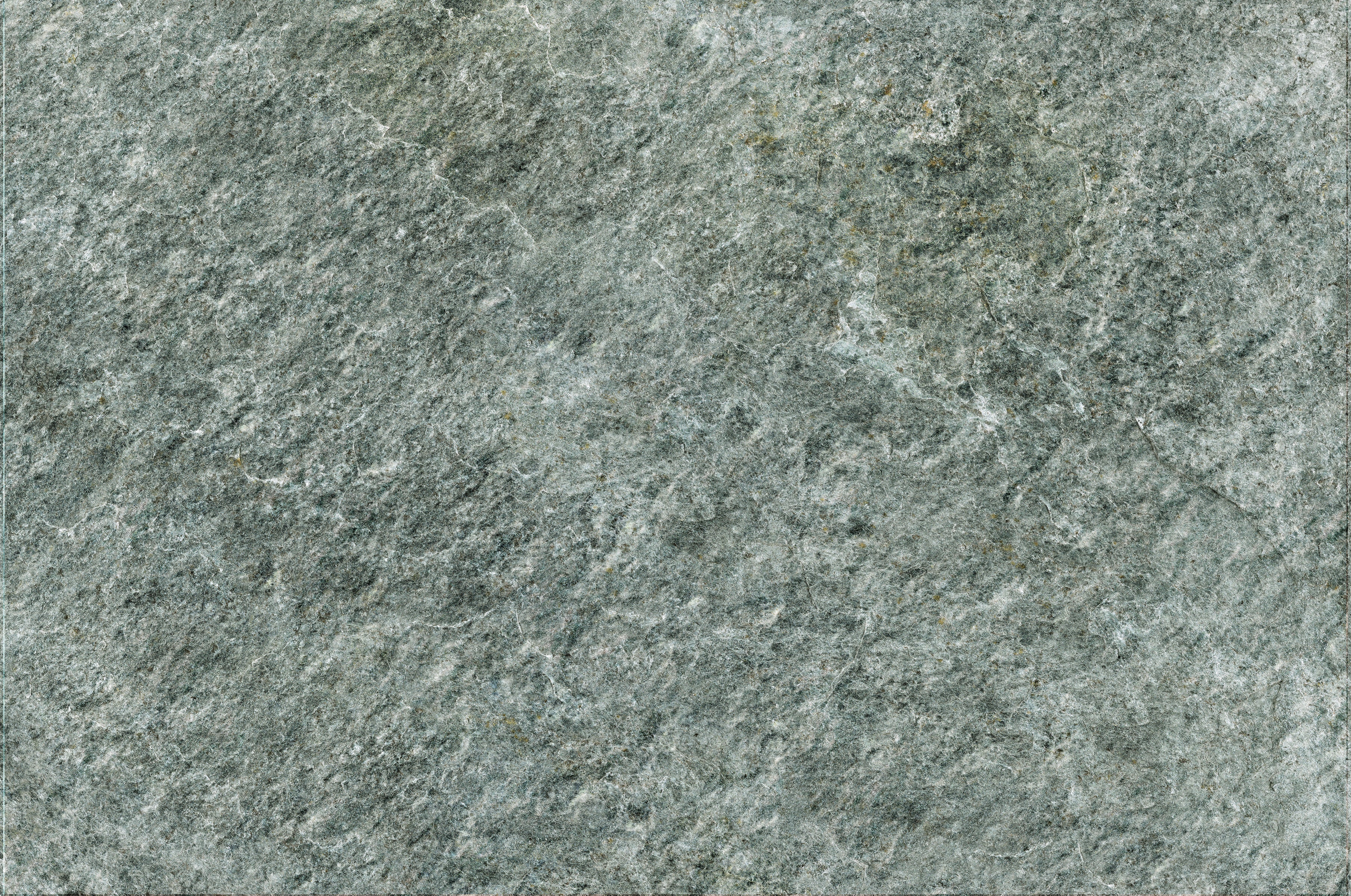 Luxury textured porcelain paving tile in soft quartzite gray, evoking natural stone with a refined matte finish for elegant outdoor spaces.