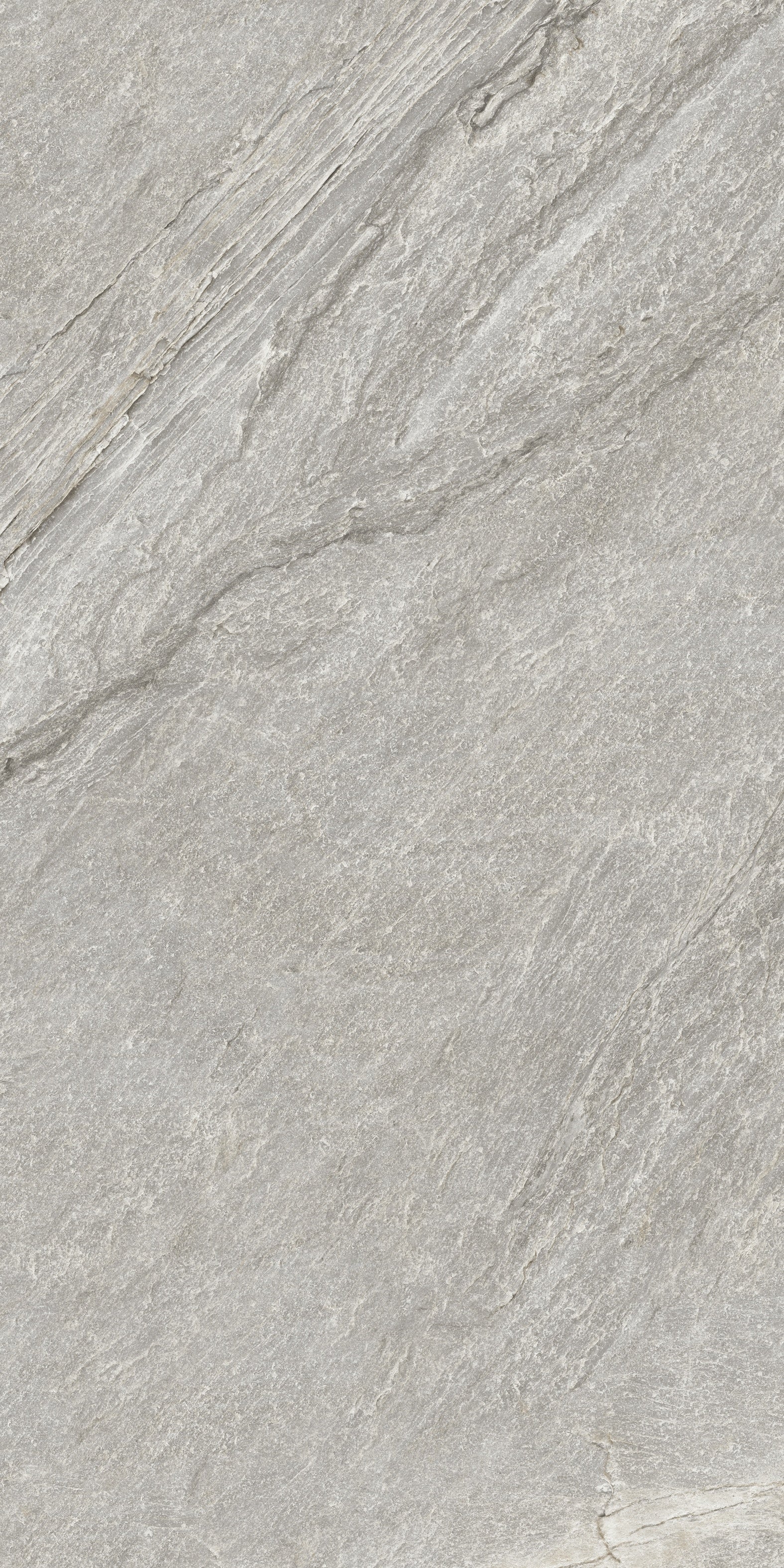 Luxurious matte porcelain tile in soft gray quartzite, evoking primordial serenity with a refined minimalist texture for elegant interiors.