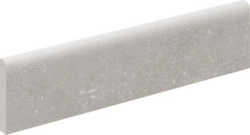 Soft gray porcelain bullnose trim with a matte, 3D-textured finish, evoking natural stone for elegant, seamless transitions.