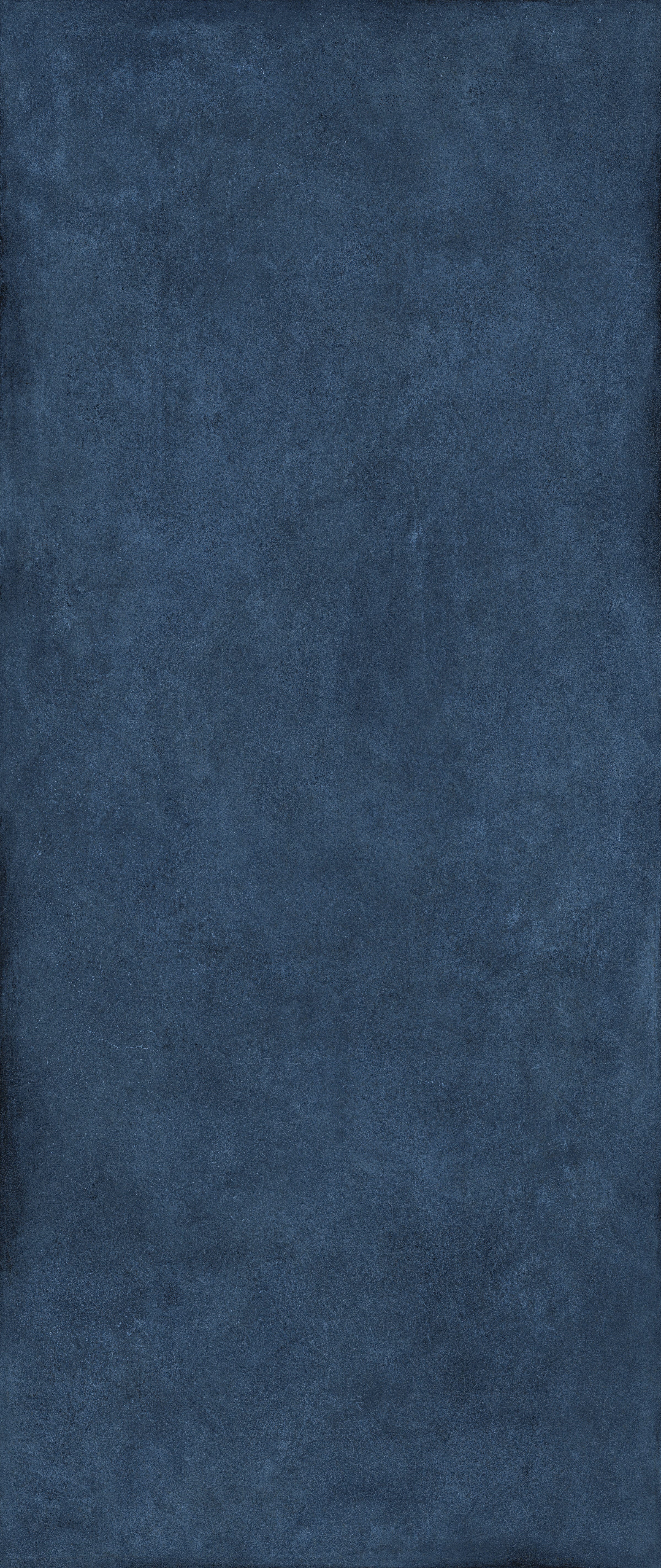 Deep blue porcelain tile with a lively 3D texture, evoking free-spirited elegance in a semi-glossy finish for bold, joyful spaces.