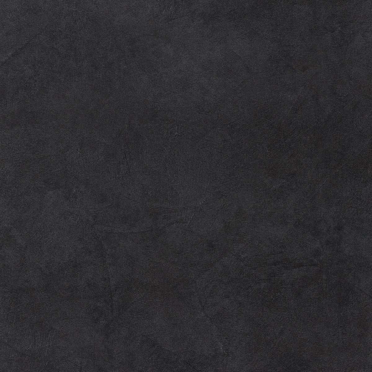 Matte black porcelain bullnose trim with a sleek, resin-inspired texture for seamless contemporary transitions in minimalist interiors.