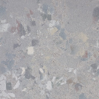 Textured terrazzo-effect porcelain tile in matte gray with raw, unpredictable chips, exuding industrial elegance and timeless sophistication.