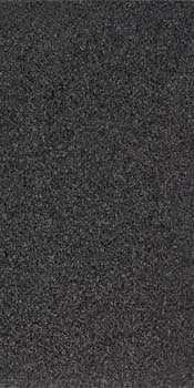 Black terrazzo-effect porcelain tile with glossy finish and elegant chips, embodying timeless luxury for sophisticated modern interiors.