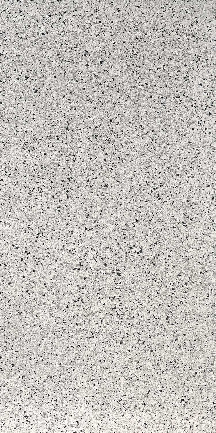 Large-format porcelain tile with a refined terrazzo look, soft white base and delicate chips, embodying timeless minimalist luxury.