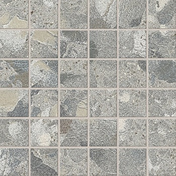 Textured terrazzo mosaic tiles in soft gray with raw, unpredictable chips, exuding industrial elegance and timeless sophistication.