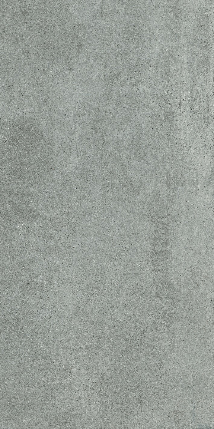 Matte gray porcelain tile with soft 3D texture, evoking refined industrial elegance in a timeless concrete-inspired finish.