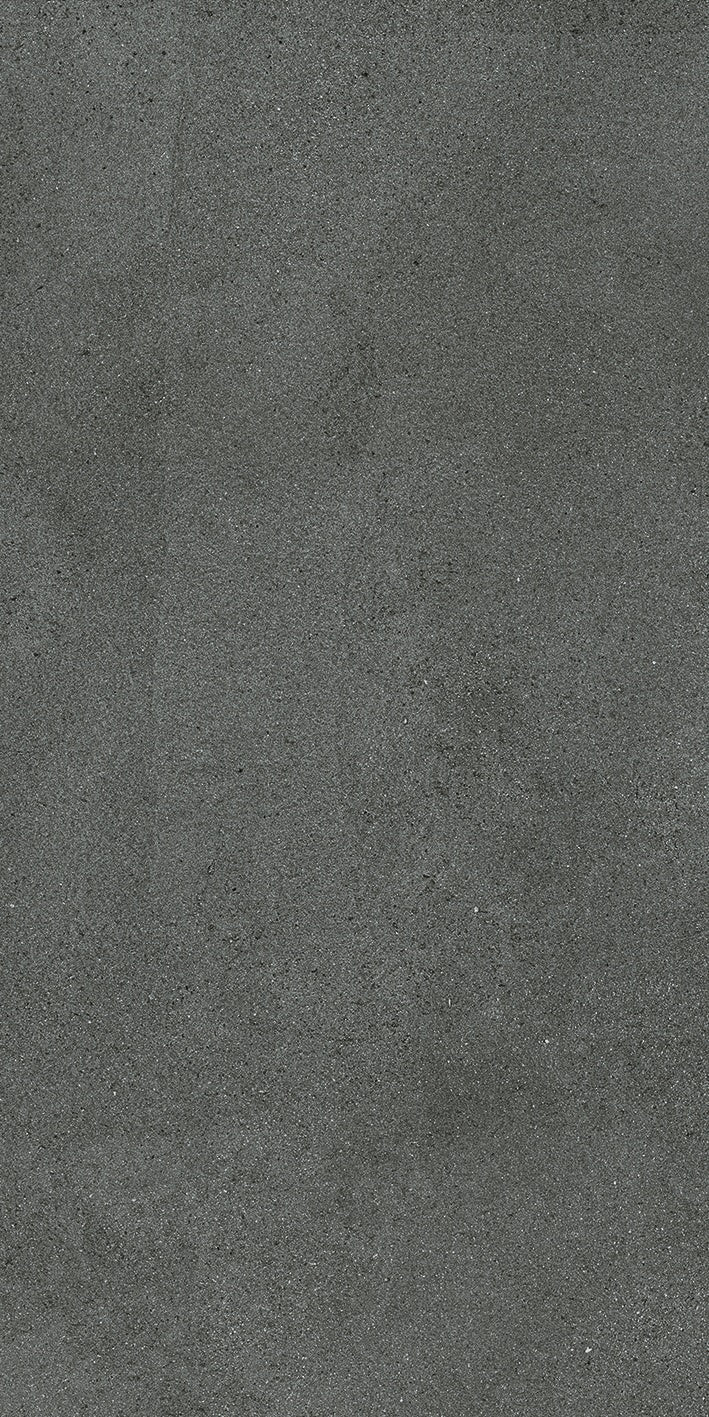 Dark gray porcelain tile with a soft, bush-hammered concrete texture, exuding timeless industrial elegance and refined monochromatic warmth.