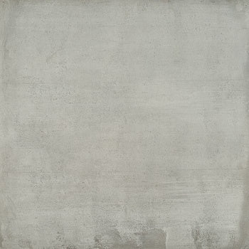 Large-format matte gray porcelain tile with industrial concrete texture, blending minimalist modernity and warm fired-clay tradition.