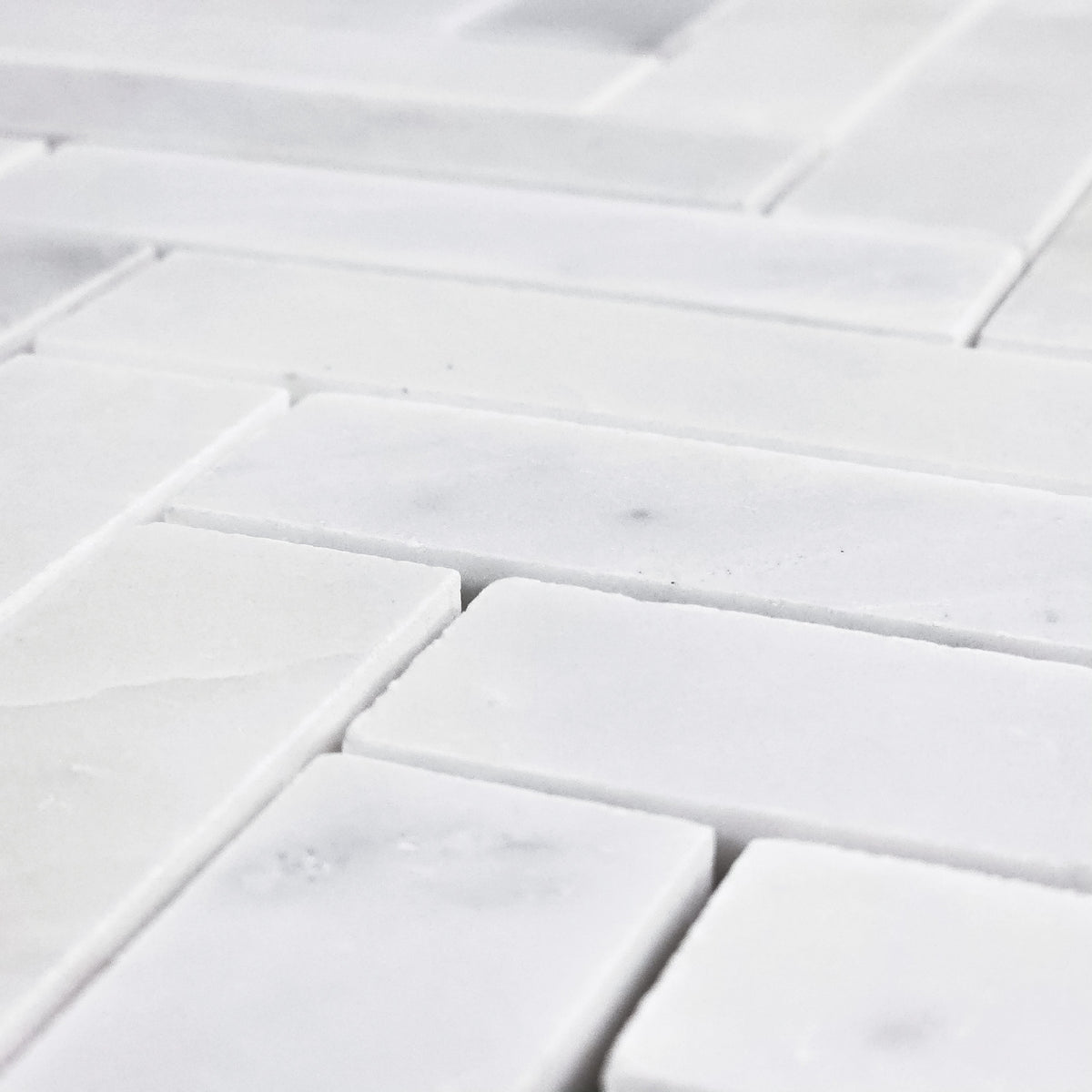 Elon Tile Herringbone tile arrangement — available at Surface Group