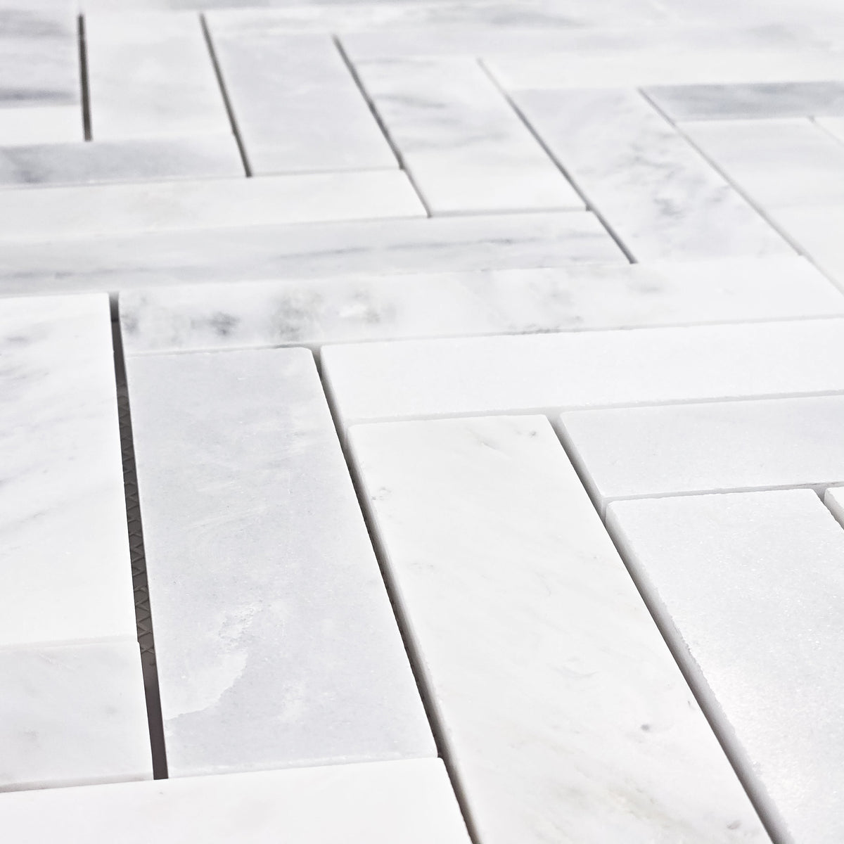 Elon Tile Herringbone tile arrangement — available at Surface Group