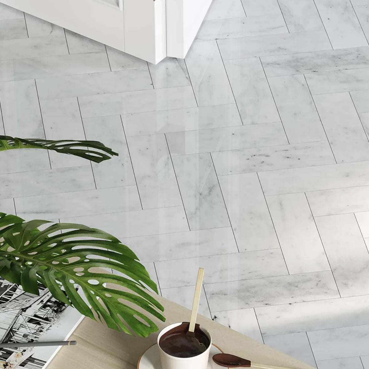 White Carrara Honed Marble White field tile, lifestyle installation view. Premium marble for floors and walls.