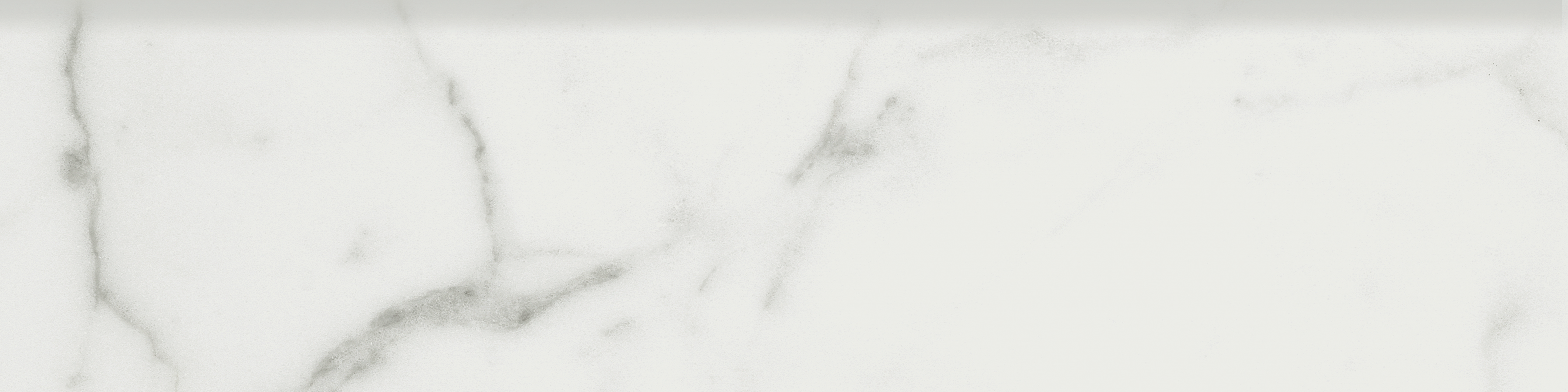 statuario venato pattern glazed porcelain bullnose molding from mayfair anatolia collection distributed by surface group international matte finish straight edge edge 3x12 bar shape