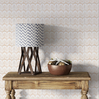 Wooden table with modern lamp and seashell bowl in front of beige/white patterned tile wall.