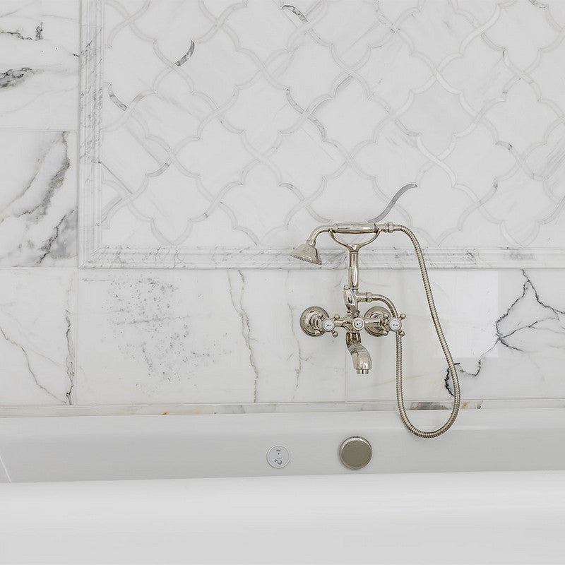 Luxurious bathroom with Calacatta Gold Extra marble tiles, intricate lattice design, vintage-style silver faucet, white bathtub.