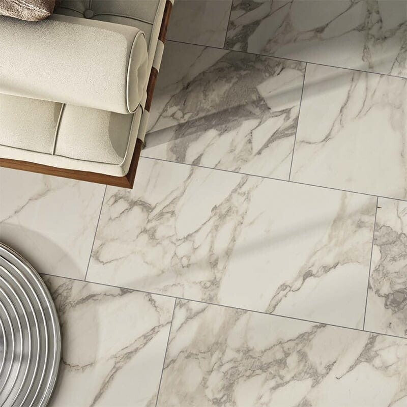 Carrara porcelain tiles in white and gray marble pattern, straight cut, semi-polished finish, floor of room with white bench and metallic table.