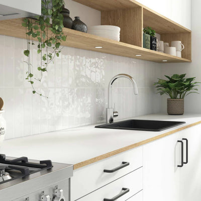 Contemporary kitchen featuring Adex Habitat Ceramic Tile backsplash in a clean white palette, with natural light accentuating the tile's unique texture and glaze.