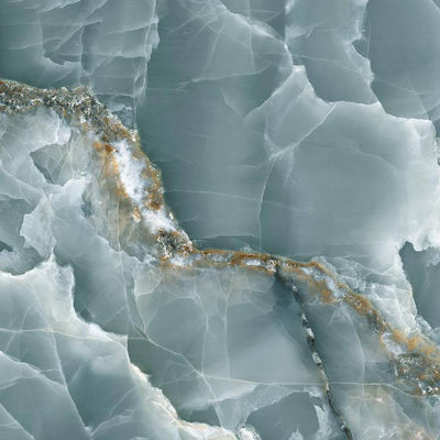 A close-up of a porcelain tile with an onyx marble effect, featuring a mixture of light green and white hues with thin, intricate veins of golden and sandy colors creating an organic pattern.