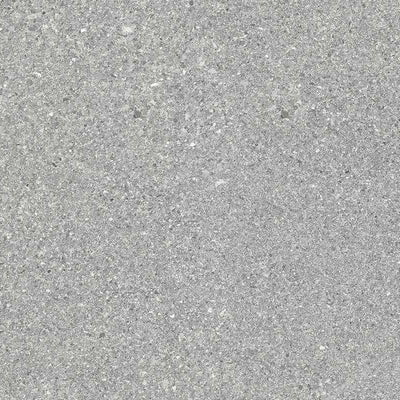 A close-up view of a fine grain grey porcelain tile with subtle speckles and a matte finish, representing a sleek and modern appearance.