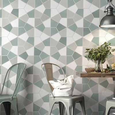 Stylish dining area with Status Ceramic tiles in a geometric pattern, soft green and white hues, under modern industrial light fixture.