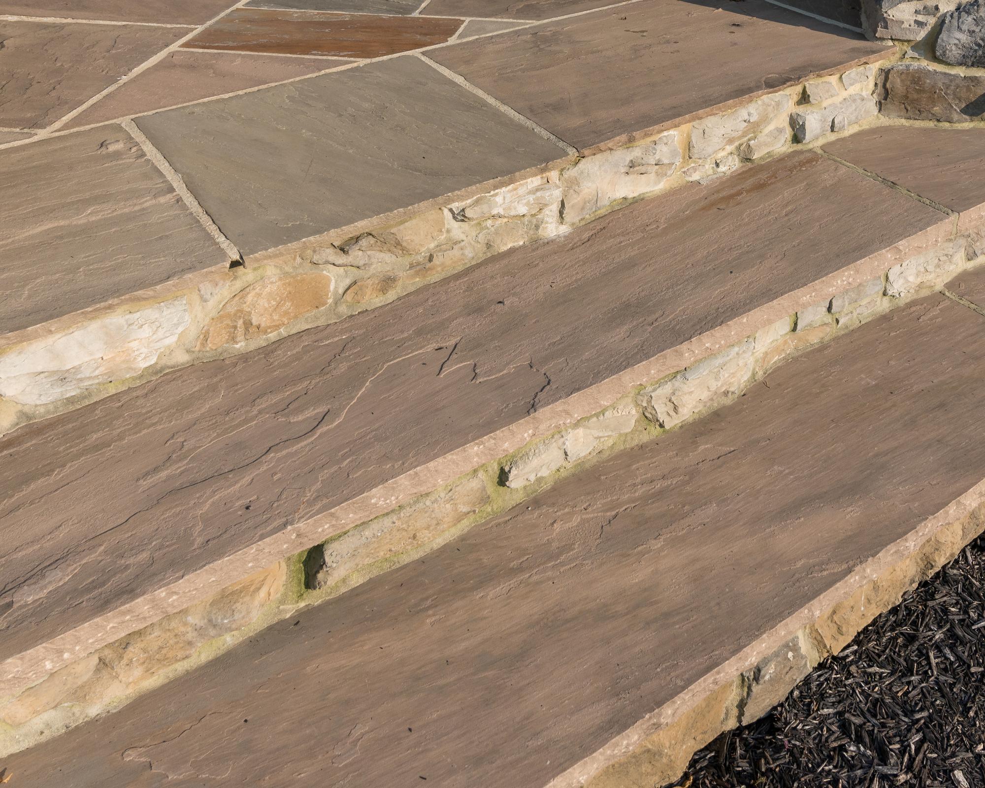 Hardscape transition pieces for seamless landscape design and aesthetic continuity