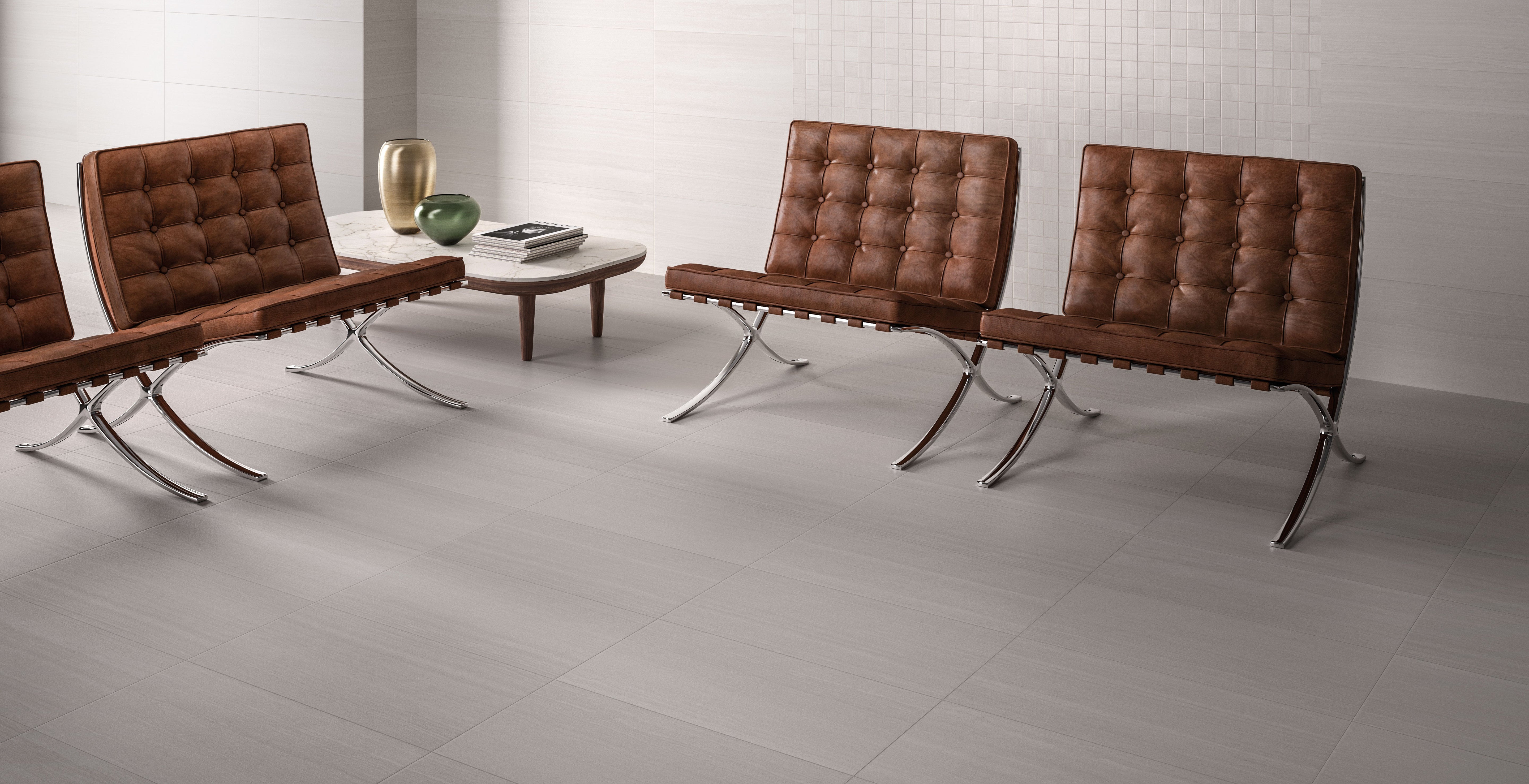 Elegant Surface Group Washington porcelain tile collection in a modern living space with stylish brown leather chairs and minimalist decor.