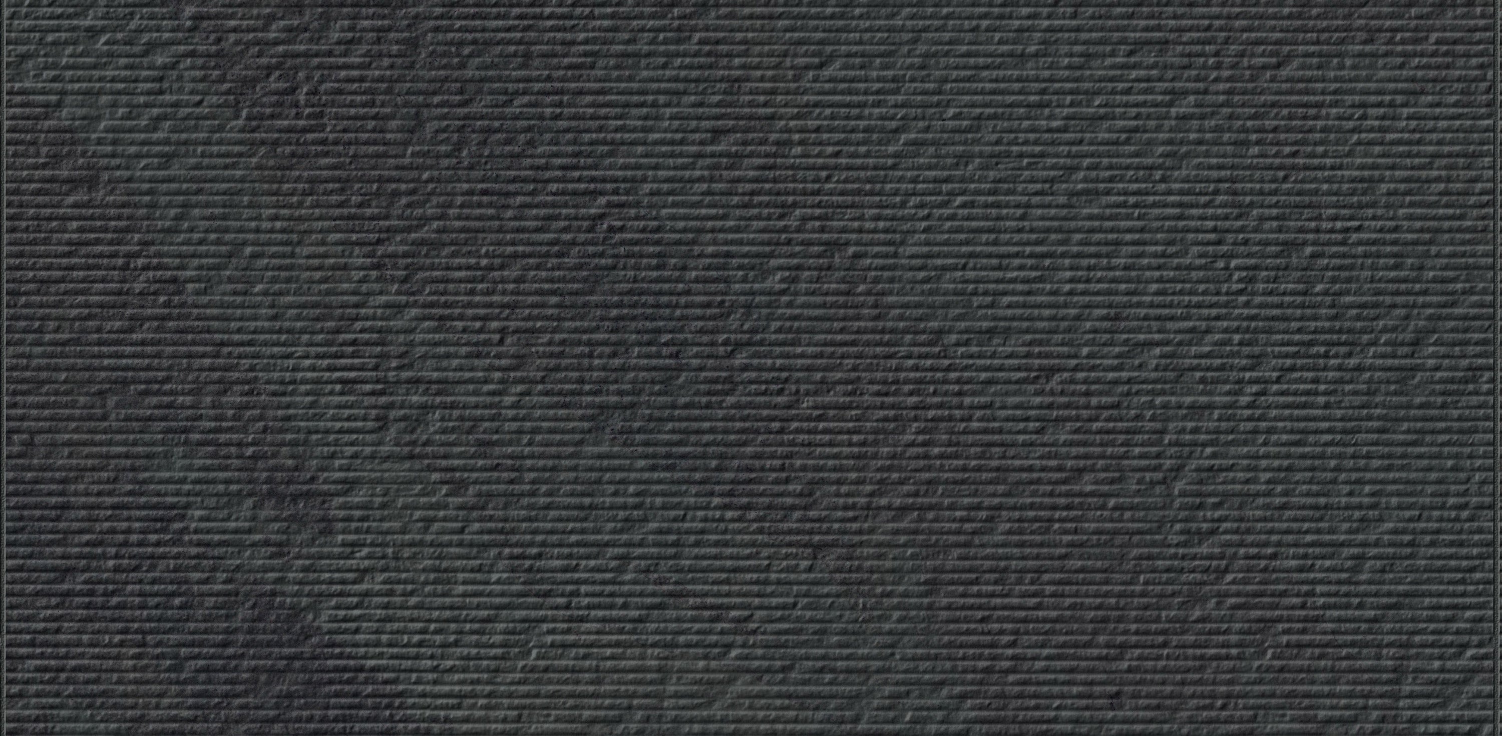 Veneer World Atelier Essence Montauk Black porcelain field tile, top-down product view, 12"×24"×11/32" size. Premium porcelain for floors and walls.